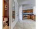 Hallway view showing access to a half bathroom and the kitchen with stainless steel appliances at 2662 Roadster Ln, Kissimmee, FL 34746