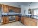 Modern kitchen with stainless steel appliances and breakfast bar overlooking living area at 2662 Roadster Ln, Kissimmee, FL 34746