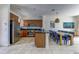 Open kitchen with stainless steel appliances and bar seating with dining area at 2662 Roadster Ln, Kissimmee, FL 34746