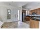 Well-lit kitchen with stainless steel appliances, tile flooring, and door to entryway at 2662 Roadster Ln, Kissimmee, FL 34746