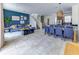 Open-concept living and dining area with blue accent wall, tile floors, and modern furnishings at 2662 Roadster Ln, Kissimmee, FL 34746