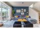 Stylish living room with modern decor, staircase, and sliding glass doors to the patio at 2662 Roadster Ln, Kissimmee, FL 34746