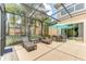 Large screened-in lanai offering multiple seating areas and views of the backyard and landscaping at 2662 Roadster Ln, Kissimmee, FL 34746