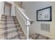 Carpeted staircase with white railing and a decorative mirror, leading to the upper level of the home at 2662 Roadster Ln, Kissimmee, FL 34746