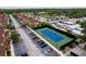 Aerial view of the community tennis court, surrounded by townhomes and lush landscaping at 2662 Roadster Ln, Kissimmee, FL 34746