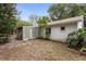 Back exterior of home featuring a lattice covered patio, lawn, and mature trees at 2942 N Chickasaw Trl, Orlando, FL 32817