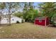 Spacious backyard featuring a storage shed, well-maintained lawn, and mature trees at 2942 N Chickasaw Trl, Orlando, FL 32817