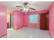 Spacious bedroom featuring tile floors, fan and an ensuite bathroom at 2942 N Chickasaw Trl, Orlando, FL 32817