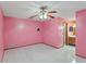 Spacious bedroom featuring tile floors, ceiling fan, and access to an ensuite bathroom at 2942 N Chickasaw Trl, Orlando, FL 32817