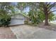 Charming single-story home with mature trees, front lawn, and two-car garage at 2942 N Chickasaw Trl, Orlando, FL 32817