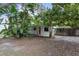 Charming single-story home with mature trees and a red front door at 2942 N Chickasaw Trl, Orlando, FL 32817