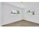 Light-filled bedroom features modern floors and dual windows at 317 Benton St, Orlando, FL 32839