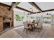 Elegant dining room with a brick fireplace, wood beams, and plenty of natural light at 317 Benton St, Orlando, FL 32839