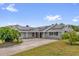 Spacious home boasts solar panels, a large driveway, and a well-manicured lawn at 317 Benton St, Orlando, FL 32839