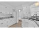 Well-lit kitchen with granite counters, white cabinets, and ample counter space at 317 Benton St, Orlando, FL 32839