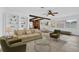 Bright living room featuring a comfortable seating area, built-in shelving, and a ceiling fan at 317 Benton St, Orlando, FL 32839