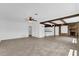 Open-concept living area with brick fireplace, beams, built-in shelves, and lots of light at 317 Benton St, Orlando, FL 32839