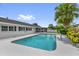 Backyard pool with a screened-in lanai, lush landscaping, and ample deck space at 317 Benton St, Orlando, FL 32839
