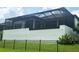 View of the home's screen-enclosed lanai, showcasing a partially fenced in backyard space at 4073 Juliana Lake Dr, Auburndale, FL 33823