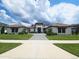 Stunning single-story home featuring a tile roof, manicured lawn, and inviting walkway leading to a grand entrance at 4073 Juliana Lake Dr, Auburndale, FL 33823