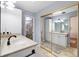 Bright bathroom with white cabinets, double vanity, and mirrored closet for ample storage at 5059 Jamaica Cir # 15, Orlando, FL 32808