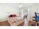 Bright bedroom with hardwood floors and access to screened porch through sliding glass doors at 5059 Jamaica Cir # 15, Orlando, FL 32808