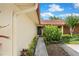 A home's entryway with a storm door, and a brown trimmed roof and walkway at 5059 Jamaica Cir # 15, Orlando, FL 32808