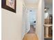 Hallway view with wood floors and closet leading to bedroom with light blue walls at 5059 Jamaica Cir # 15, Orlando, FL 32808