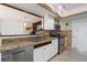 Cozy kitchen featuring granite counters, stainless appliances, and tiled floors with an open serving bar at 5059 Jamaica Cir # 15, Orlando, FL 32808