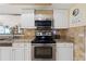 Kitchen features granite counters, stainless oven, range, and microwave, plus bright white cabinetry at 5059 Jamaica Cir # 15, Orlando, FL 32808