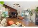 Comfortable living room with hardwood floors, brown accent wall, stylish furniture, and slider to outdoor area at 5059 Jamaica Cir # 15, Orlando, FL 32808