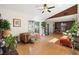 An open concept living room, with wood floors and views into the dining area at 5059 Jamaica Cir # 15, Orlando, FL 32808