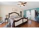 This spacious main bedroom features a ceiling fan, hardwood floors, and a walk in closet at 5059 Jamaica Cir # 15, Orlando, FL 32808