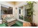 Charming screened patio with wicker furniture, decorative cushions, and sliding glass door access at 5059 Jamaica Cir # 15, Orlando, FL 32808