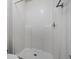 Modern all-white shower with tile surround and chrome fixture at 5671 Sycamore Canyon Dr, Kissimmee, FL 34758
