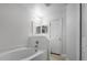 Bathroom featuring a soaking tub, mirrors, and updated lighting at 5671 Sycamore Canyon Dr, Kissimmee, FL 34758