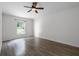 Large bedroom featuring a ceiling fan, window, and wood-look flooring at 5671 Sycamore Canyon Dr, Kissimmee, FL 34758