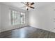Bedroom features hardwood floors, large window, and ceiling fan at 5671 Sycamore Canyon Dr, Kissimmee, FL 34758