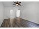 Bright bedroom showcasing archway, a ceiling fan, and wood-look flooring at 5671 Sycamore Canyon Dr, Kissimmee, FL 34758