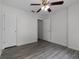 Bedroom with hardwood floors, ceiling fan, and white trim and doors at 5671 Sycamore Canyon Dr, Kissimmee, FL 34758