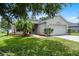 Well maintained single story home with lush green lawn and mature trees at 5671 Sycamore Canyon Dr, Kissimmee, FL 34758