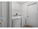 Convenient laundry room with appliances, overhead shelving, and a neutral door at 5671 Sycamore Canyon Dr, Kissimmee, FL 34758