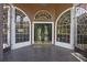 Grand entryway showcasing double doors, arched windows, and dark tile flooring at 6631 Crenshaw Dr, Orlando, FL 32835