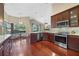 Modern kitchen featuring stainless steel appliances, granite counters, and hardwood flooring at 6631 Crenshaw Dr, Orlando, FL 32835