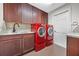 Laundry room with granite counters, sink, and a red washer and dryer at 6631 Crenshaw Dr, Orlando, FL 32835