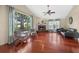 Bright living area with hardwood floors, fireplace, and large windows offering scenic views at 6631 Crenshaw Dr, Orlando, FL 32835