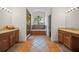 Well-lit bathroom with double sinks, a large window over the tub, and a walk-in shower at 6631 Crenshaw Dr, Orlando, FL 32835