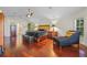 Spacious main bedroom featuring hardwood floors, a seating area, and a decorative ceiling fan at 6631 Crenshaw Dr, Orlando, FL 32835