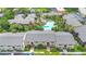 An aerial view of the condo complex with a swimming pool, mature trees, and ample parking at 754 E Michigan St # 182, Orlando, FL 32806