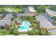 Aerial view showcasing the community pool surrounded by palm trees and apartment buildings at 754 E Michigan St # 182, Orlando, FL 32806